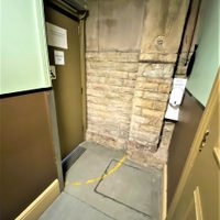 Internal stones wall next to accessible entrance