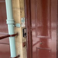 Maroon door with buzzer on left hand side