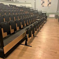 front of the auditorium, there is a gap in the chairs in the front row for wheelchair users