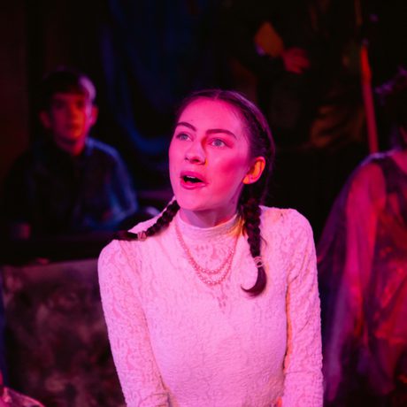 Young female performer with two pigtails looking into distance