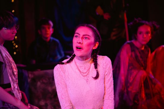 Young female performer with two pigtails looking into distance