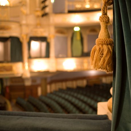 Close up of curtain with Buxton Opera House auditorium in the background