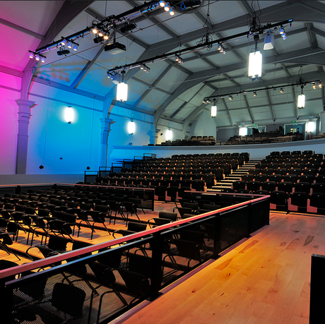 Image of the Pavilion Arts Centre auditorium, showing high ceilings and 3 levels of black seating