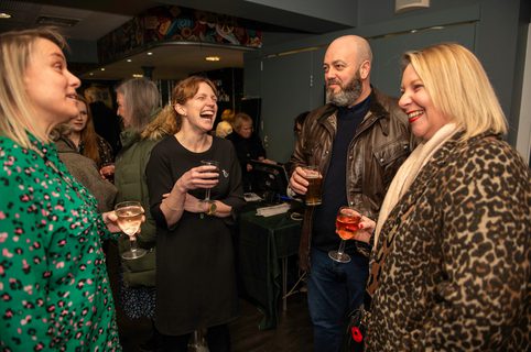 Corporate members at event chatting and having a drink together