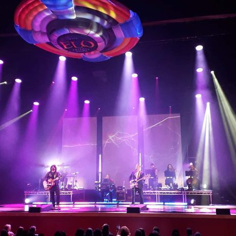 Multiple purple spotlights covering a stage