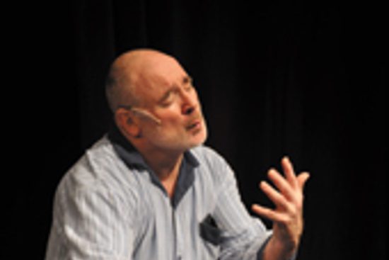 Man in pyjamas holding out his arms pretending to kiss an imaginary person in front of him