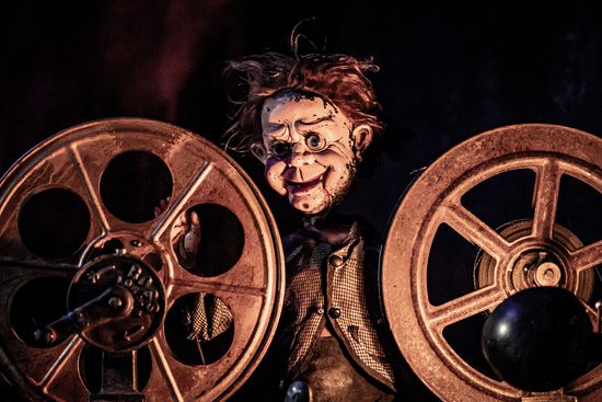 A creepy doll peeking out between two wheels.