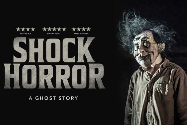 Text that reads "Shock Horror: A Ghost Story" on a black background, next to an image of a spooky doll.
