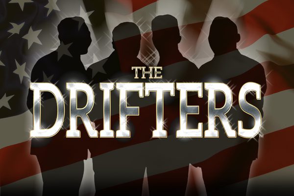 Silhouettes of four men standing in front of the American flag.