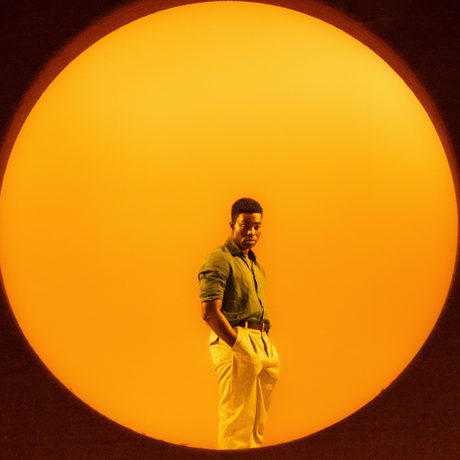 A man stands inside a large circle. The Circle is glowing with orange light.