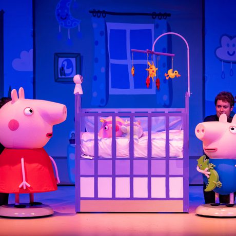 Peppa pig and George look into a cot where baby Evie is asleep.