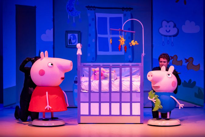 Peppa pig and George look into a cot where baby Evie is asleep.