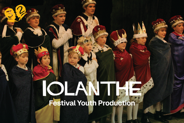 A group of young people in robes and crowns.