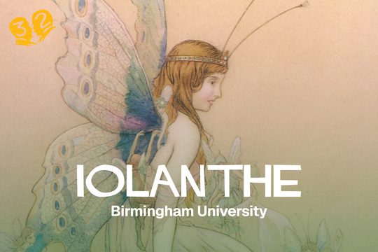 A fairy with red hair and colourful wings.