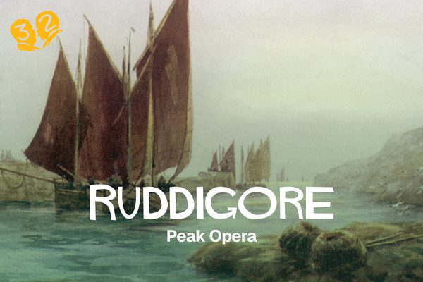 A ship with large red sails in a bay.