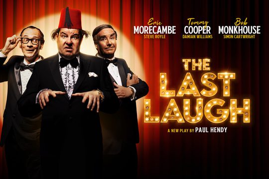 Tommy Cooper, Eric Morecambe, and Bob Monkhouse in black suits, standing in front of a red curtain. Tommy Cooper is wearing a red fez.