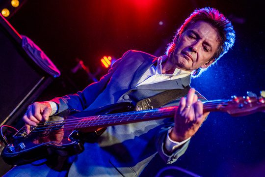 Bruce Foxton playing the bass guitar.