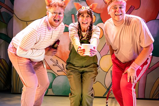 The Three Little Pigs huddle together and smile.