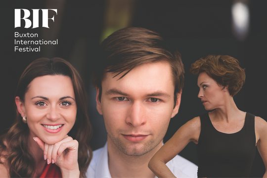 Three people pose a man in the middle with brown hair looks serious while to woman too his left smiles wth a hand under her chin. To his right an image of a woman with short brown hair and a black vest top looks to this side.