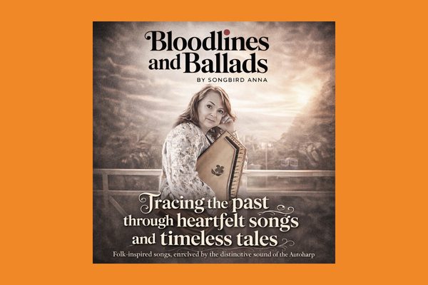A grey image of a white woman holding a harp-like instrument. Text: Bloodlines and Ballads by Songbird Anna. Tracking the past though heartfelt songs and timeless tales.