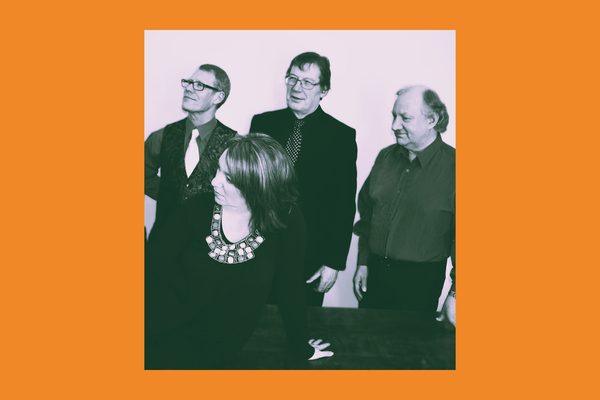 Black and white image of three men and one woman looking over to one side.