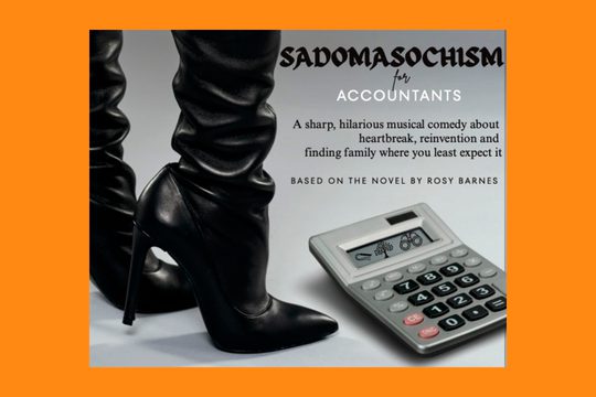 A pair of black high heeled boots next to a calculator.