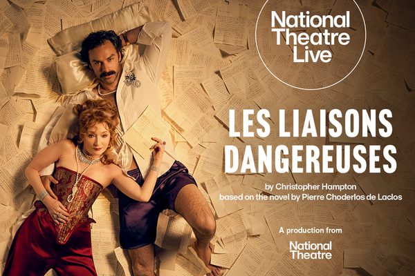 A man and a woman in fancy clothing and jewellery lie on the ground. The floor is covered in handwritten letters.