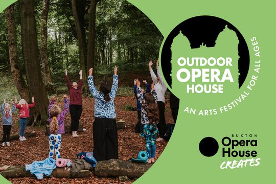 Families in the woods with their arms stretched in the air.
