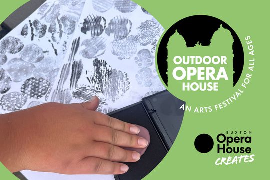 A person's hand pressing clay into black ink, and then transferring onto paper. Outdoor Opera House logo and Buxton Opera House Creates logo.