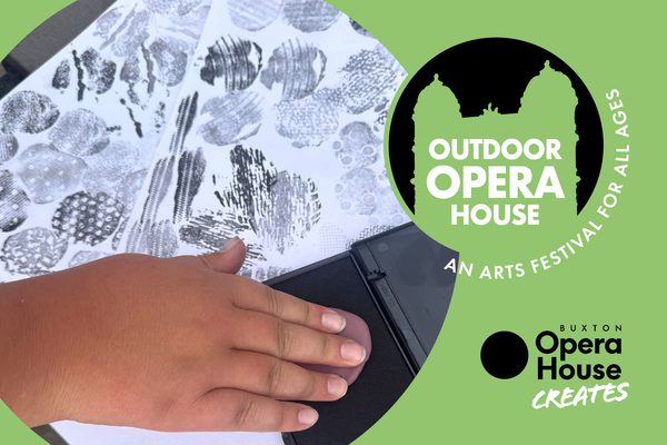 A person's hand pressing clay into black ink, and then transferring onto paper. Outdoor Opera House logo and Buxton Opera House Creates logo.