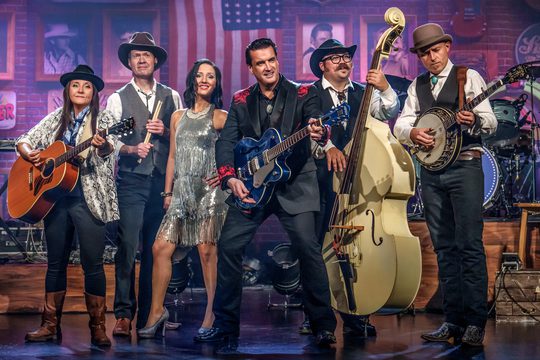 A band playing various instruments and wearing cowboy hats.