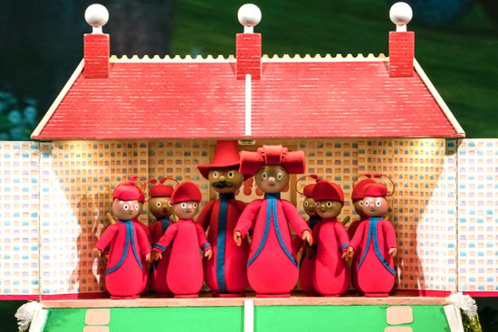 A family of small red pupped in a doll's house.