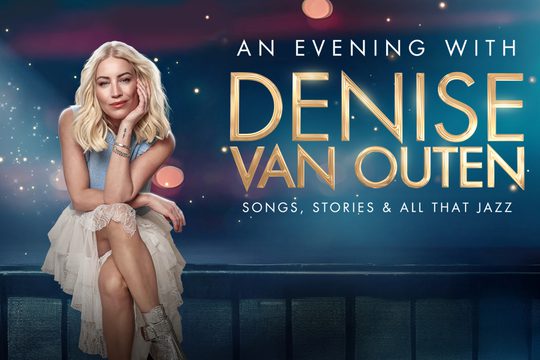 Denise sat on a bench with her arms crossed, head leaning on one hand.