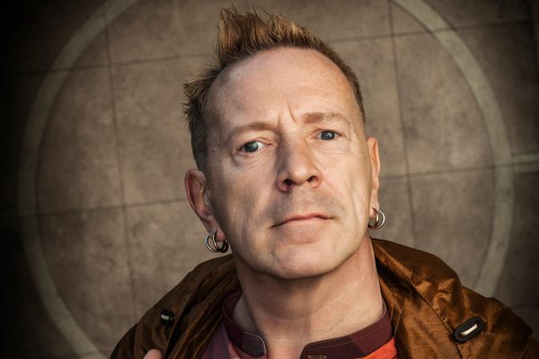 John with spikey hair and multiple earrings.