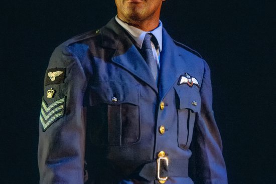 Man in military uniform looks out to audience