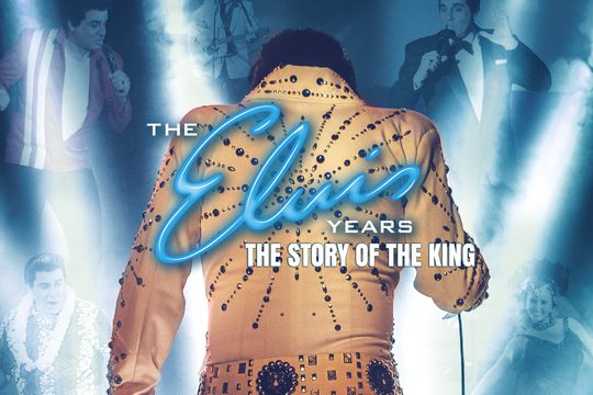 The back of a brunette man in a white jacket covered in jewels, with blue neon writing saying The Elvis Years.