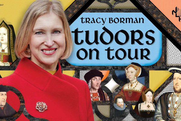 A blonde woman in a red coat stands in front of a collage of Tudor portraits.