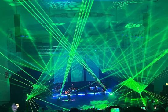 A stage covered in green lasers going in every direction.