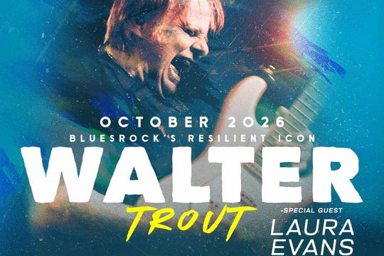 Walter Trout playing the guitar with his mouth open, as if he is shouting.