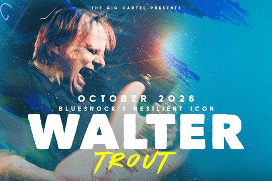 Walter Trout playing the guitar with his mouth open, as if he is shouting.