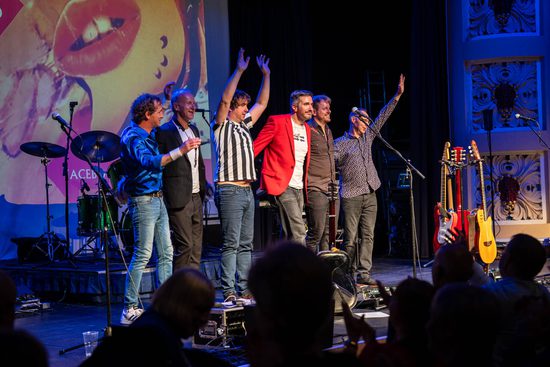 The band taking a bow on stage.