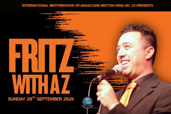 A man in a black suit and yellow tie speaking into a microphone against an orange background. Orange text on a black background: Fritz with a Z