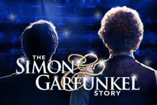 The backs of two men looking out into a full theatre.