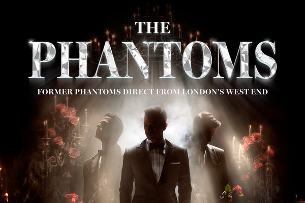 Three men in suits standing in smoke, next to roses and candles.