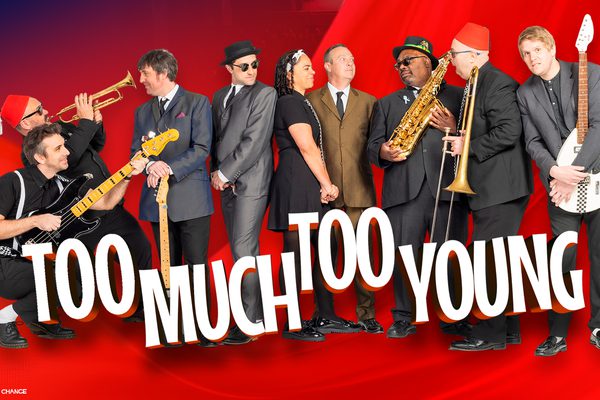 A red background with a band standing in a line, holding various different musical instruments.