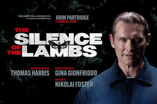 A man in a blue shirt looking scarily at the camera. There are moths on a dark background. Text: The Silence of the Lambs. John Partridge is Hannibal Lecter.
