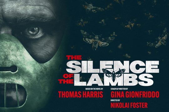 A face staring out of a mask covering the person's mouth. There are moths in the background.