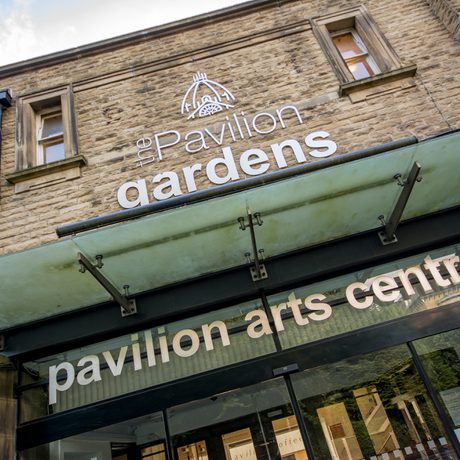 Exterioir of the pavilion gardens entrance, a glass canopy above the door