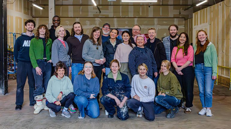 A group of people smiling posing for a photo.