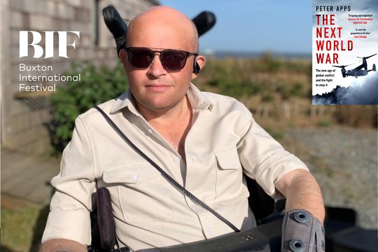A bald man wearing sunglasses and a white, unbuttoned shirt against a blurred out backdrop of skies and uneven grasslands, a book titled 'The Next World War' by Peter Apps sits in the top right-hand corner.